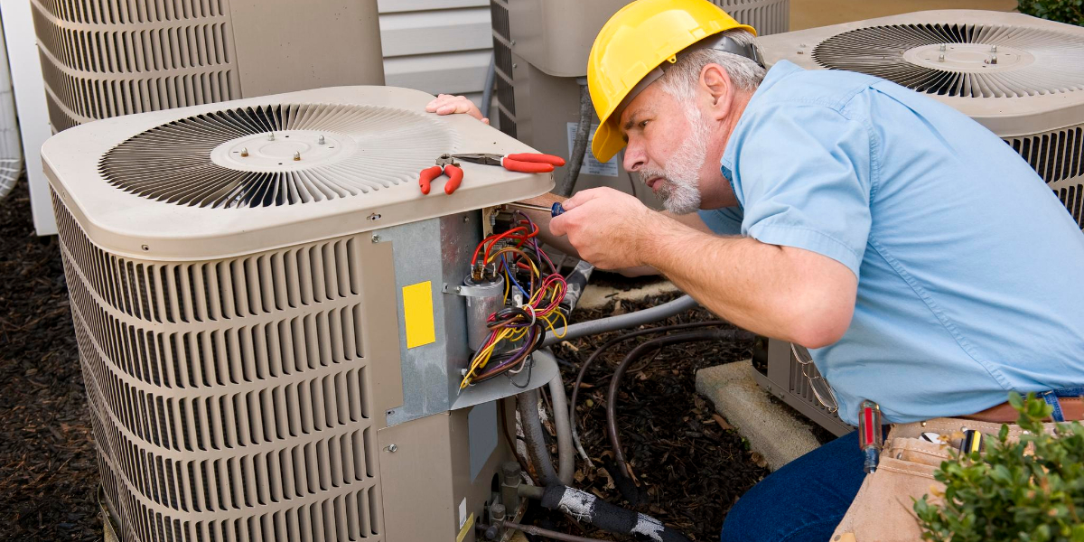 worker fixing AC